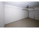 Spacious garage with white walls and an epoxy-coated floor at 5760 Lakeview Dr, Powder Springs, GA 30127