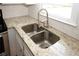Updated kitchen with granite countertops, stainless steel sink, and white subway tile backsplash at 5760 Lakeview Dr, Powder Springs, GA 30127