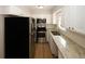 Bright kitchen featuring white shaker cabinets, granite countertops, and stainless steel appliances at 5760 Lakeview Dr, Powder Springs, GA 30127