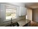 Kitchen with white cabinets, granite counters, subway tile backsplash, and view to the backyard at 5760 Lakeview Dr, Powder Springs, GA 30127