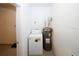 Laundry room with washer, water heater, and white paneled walls at 5760 Lakeview Dr, Powder Springs, GA 30127