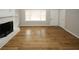 Living room with hardwood floors, white fireplace, and ample natural light at 5760 Lakeview Dr, Powder Springs, GA 30127