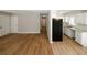 Living room with wood floors and a view into the kitchen and hallway at 5760 Lakeview Dr, Powder Springs, GA 30127