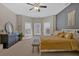 Bright main bedroom featuring a neutral color palette, bay window, and ceiling fan at 5017 Cambridge Ln, Villa Rica, GA 30180