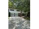 Ranch style home with two-car garage and mature landscaping at 4681 Mercer Rd, Stone Mountain, GA 30083