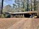 Brick ranch home with covered porch and mature trees at 4730 Janice Dr, Atlanta, GA 30337