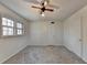 Bright bedroom with ceiling fan, large windows, and grey carpet at 5431 E Wind Sw Dr, Lilburn, GA 30047