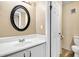 Main bathroom with white vanity and oval mirror at 1192 Ashborough Se Dr # E, Marietta, GA 30067