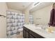 Clean bathroom with shower/tub combo and dark vanity at 1198 Lake Point Way, Suwanee, GA 30024