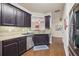 Kitchen with dark wood cabinets, granite countertops, and stainless steel appliances at 1198 Lake Point Way, Suwanee, GA 30024