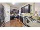 Kitchen with dark brown cabinets, granite countertops, and stainless steel appliances at 1198 Lake Point Way, Suwanee, GA 30024