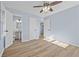 Light blue bedroom with wood-look floors and ensuite bathroom at 111 Charles Pl, Cumming, GA 30040