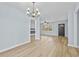 Dining room with hardwood floors and access to kitchen at 111 Charles Pl, Cumming, GA 30040