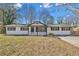 Newly renovated ranch home with modern exterior and landscaping at 111 Charles Pl, Cumming, GA 30040