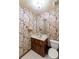 Powder room with updated vanity and floral wallpaper at 1845 Branch Valley Dr, Roswell, GA 30076