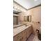 Bathroom with a vanity, large mirror, and tiled bathtub at 1845 Branch Valley Dr, Roswell, GA 30076