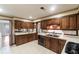 Bright kitchen with wood cabinets, tile floors, and a view into adjacent dining area at 1845 Branch Valley Dr, Roswell, GA 30076