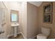 Stylish powder room with pedestal sink and framed art at 2298 Treaty Ln, Douglasville, GA 30135