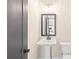 Powder room with pedestal sink and dark gray door at 106 Red Oak Ln, Carrollton, GA 30116