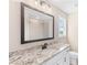 Bathroom with granite countertop, white sink, and framed mirror at 106 Red Oak Ln, Carrollton, GA 30116