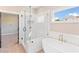 Main bathroom with soaking tub, glass shower, and modern fixtures at 106 Red Oak Ln, Carrollton, GA 30116