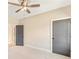 Bright bedroom with carpet, ceiling fan and two doors at 106 Red Oak Ln, Carrollton, GA 30116