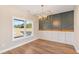 Bright dining room with wood-look floors and large window at 106 Red Oak Ln, Carrollton, GA 30116