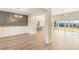 Open dining room with wood-look floors and modern chandelier at 106 Red Oak Ln, Carrollton, GA 30116