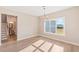 Sunlit dining room with hardwood floors and a view of the backyard at 106 Red Oak Ln, Carrollton, GA 30116