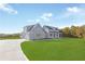 Gray farmhouse-style home with large yard and driveway at 106 Red Oak Ln, Carrollton, GA 30116