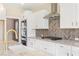 Modern kitchen with white cabinets, granite countertops and a herringbone backsplash at 106 Red Oak Ln, Carrollton, GA 30116