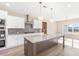 Open concept kitchen with island, white cabinets and a view of the backyard at 106 Red Oak Ln, Carrollton, GA 30116