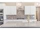 Modern kitchen with white cabinets, granite countertops, and gold fixtures at 106 Red Oak Ln, Carrollton, GA 30116