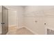 Bright laundry room with built-in shelving and tile floor at 106 Red Oak Ln, Carrollton, GA 30116