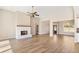 Open living room with hardwood floors and a white brick fireplace at 106 Red Oak Ln, Carrollton, GA 30116