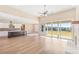 Open living space with kitchen island, hardwood floors, and sliding doors to a view at 106 Red Oak Ln, Carrollton, GA 30116