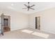 Main bedroom with carpeted floor, ceiling fan, and access to bathroom and hallway at 106 Red Oak Ln, Carrollton, GA 30116
