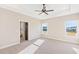 Main bedroom with carpeted floor, ceiling fan, and access to a bathroom at 106 Red Oak Ln, Carrollton, GA 30116