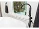 Close-up of modern black freestanding tub faucet in a bright bathroom at 650 Hunterhill Court, Roswell, GA 30075