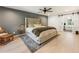 Spacious main bedroom with plush carpeting, a tufted headboard, and barn door leading to ensuite at 650 Hunterhill Court, Roswell, GA 30075