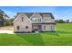 Two-story home with brick and gray siding, and a lush green lawn at 102 Red Oak Ln, Carrollton, GA 30116