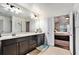 Modern bathroom with double vanity, dark cabinets, and a view of the bedroom at 132 Eagle Rock Dr, Acworth, GA 30101