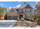 Brick two-story house with a two-car garage and landscaped front yard at 132 Eagle Rock Dr, Acworth, GA 30101