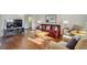 Bright living room with hardwood floors, comfy seating, and large TV at 215 Piedmont Ne Ave # 1406, Atlanta, GA 30308