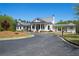 White farmhouse-style clubhouse with a large porch and covered pavilion at 67 Rocking Wood Vw, Dallas, GA 30157