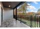 Private balcony with modern railing, tile flooring, and scenic backyard views at 1198 Milmar Nw Dr, Atlanta, GA 30327