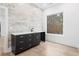 Modern bar area with dark cabinets, marble backsplash, and natural light at 1198 Milmar Nw Dr, Atlanta, GA 30327