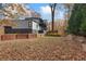 Modern two-story home with a mix of gray and black siding, wooden fence, and autumn foliage at 1198 Milmar Nw Dr, Atlanta, GA 30327