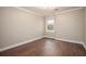 Simple bedroom with hardwood floors and a window providing natural light at 31 Brittany Ne Way, Atlanta, GA 30324