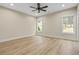 Spacious bedroom with two windows, ceiling fan, and light flooring at 447 Teague Nw Dr, Kennesaw, GA 30152